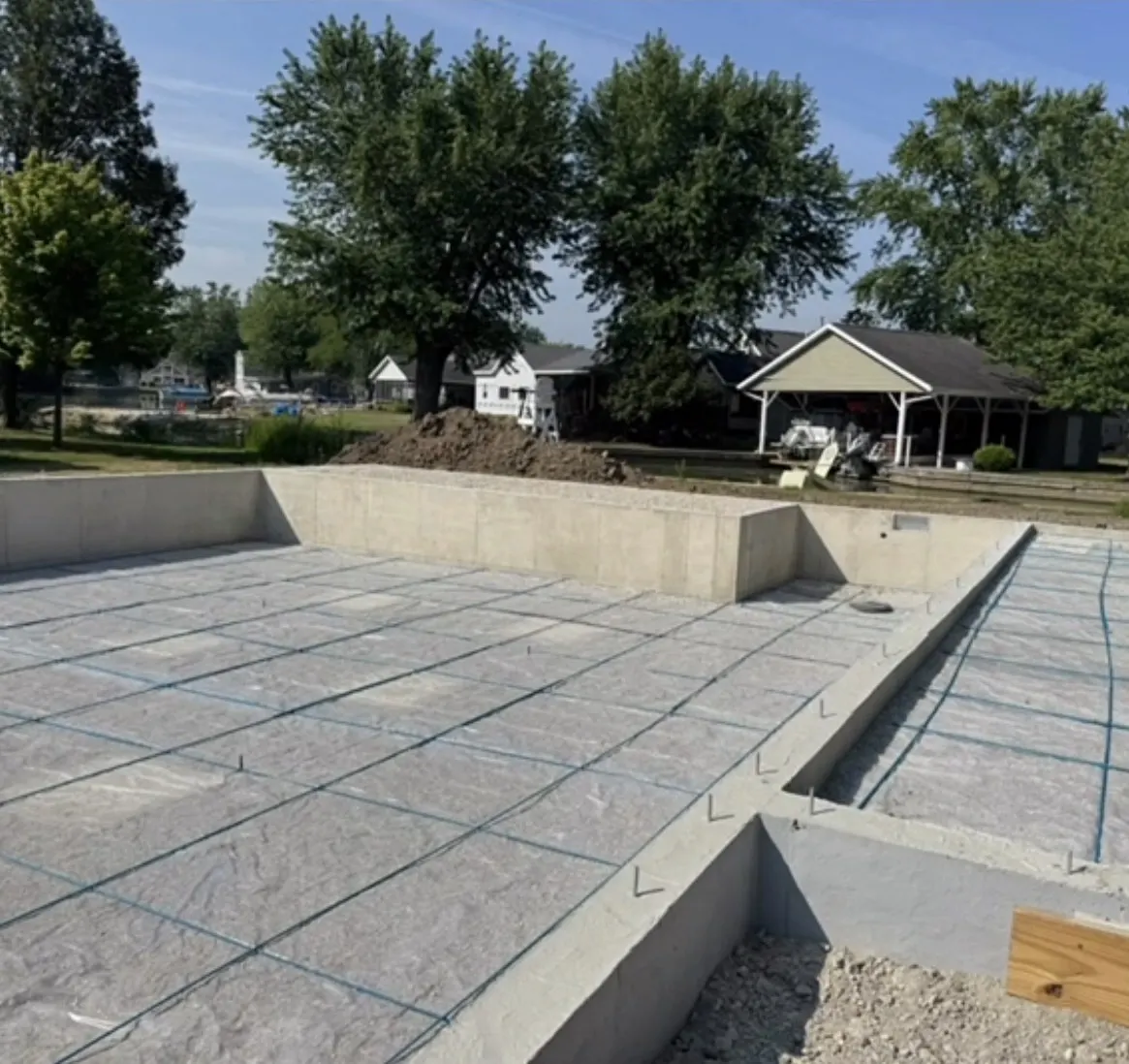 Prepared concrete slab with foundation walls and reinforcement grid
