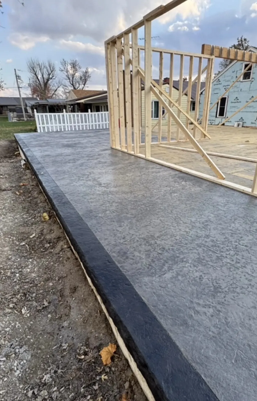 Finished concrete slab for a framed building addition